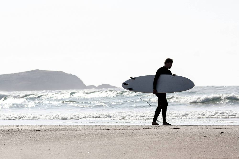 Surfer walking along the Gold Coast beach