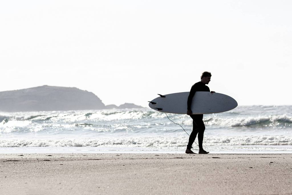 Surfer walking along the Gold Coast beach